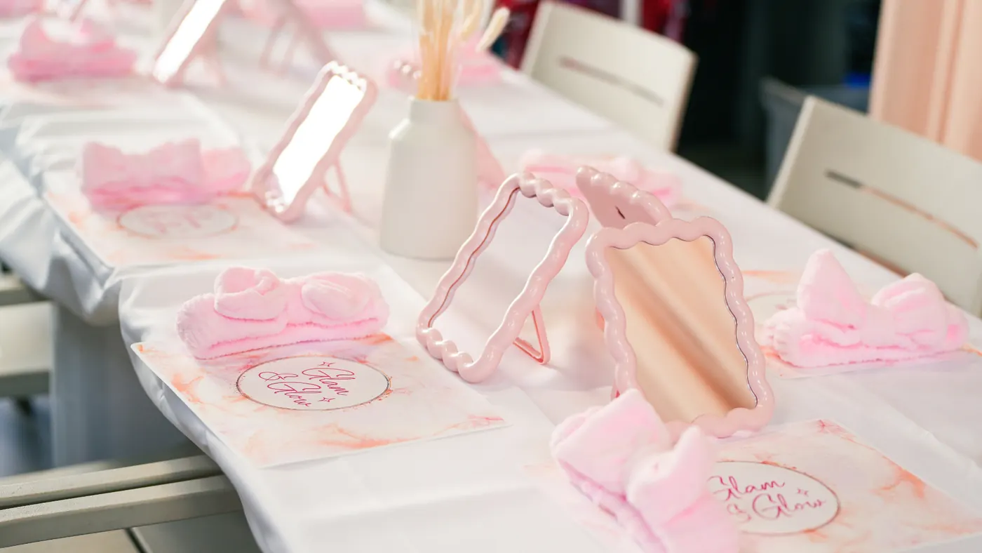 Glam & Glow party table with pink mirrors and party favours